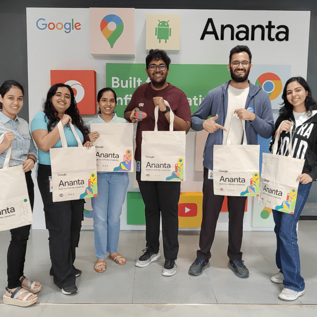 A corporate team holding the tote bags they painted at a Kitsters workshop