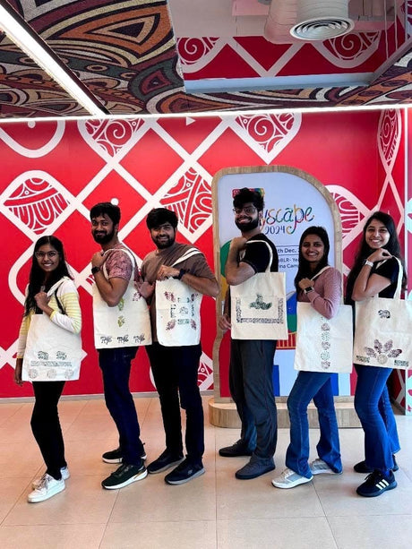 Six colleagues holding tote bags they block-printed at a Google Joyscape 2024 team event
